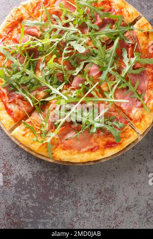 Köstliche Pizza mit Prosciutto und arugulären italienischen Snacks. Vertikale Draufsicht von oben Stockfoto