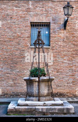 Mittelalterlicher Brunnen in einem Innenhof, Ferrara, Italien Stockfoto