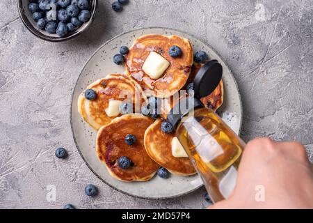 Buttermilch-Heidelbeerpfannkuchen mit Ahornsirup Stockfoto