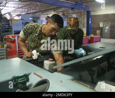 USA Marine Corps Sgt. Christian Muñoz, Left, Bodentechniker, Marine Aviation Logistics Squadron 13 (Mals-13), 3. Marine Aircraft Wing, überwacht eine Inspektion des Eagle TT-8 Flugzeugschleppers, durchgeführt von CPL. Jillian Duke, Bodentechniker, Mals-13, an der Marine Corps Air Station Yuma, Arizona, 13. Juli 2022. Die Aufgaben von Muñoz bestehen in der regelmäßigen Wartung und Fehlersuche von Hydraulik, elektrischen Komponenten, Dieselmotoren und Kranen. Stockfoto