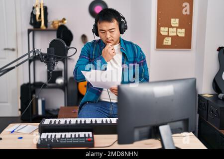 Junger chinesischer Sänger singt Lied im Musikstudio Stockfoto