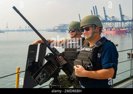 JAKARTA, Indonesien (25. Juli 2022) Torpedoman 2. Class Colin Williams, Left, aus Lemars, Iowa, Und Torpedoman 1. Klasse Robert Hollister, rechts, aus Camarillo, Kalifornien, beide dem Emory S. Land-Klasse-U-Boot-Tender USS Frank Cable (AS 40) zugeteilt, man ein M2A1 .50 Kaliber Maschinengewehr, wenn das Schiff Jakarta, Indonesien, verlässt, 25. Juli 2022. Frank Cable ist derzeit auf Patrouille und führt expeditionäre Wartungs- und Logistikaufgaben durch, um ein freies und offenes Indo-Pacific im US-Flottenbereich 7. zu unterstützen. Stockfoto