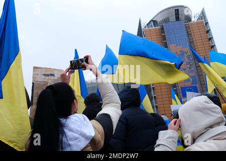 Brüssel, Belgien. 23. Januar 2023. Demonstranten halten Schilder und schwenken ukrainische Flaggen während einer Demonstration zur Unterstützung der Ukraine außerhalb eines EU-Hauptquartiers in Brüssel, Belgien, am 23. Januar 2023. Kredit: ALEXANDROS MICHAILIDIS/Alamy Live News Stockfoto