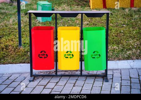 Mehrfarbige Behälter für die getrennte Abfallsammlung bügeln. Abfallrecycling. Stockfoto