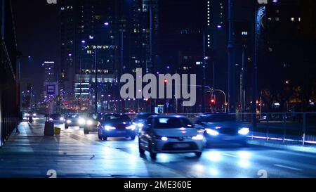 Warschau, Polen. 23. November 2022 Abendliches Stadtleben im Zentrum von Warschau. Autos auf der Straße. Straßenlaternen in der Stadt bei Nacht. Stockfoto