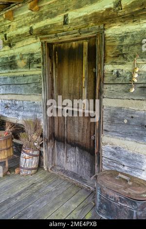 Die rustikale hintere Veranda einer Pionierhütte in der Whippoorwill Academy and Village in Ferguson, North Carolina. Stockfoto