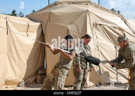 USA Army PFC. Jayden Redmond, Left, Sgt. Jacqulne Blackiston, Middle und Master Sgt. Stephan Ridenour, alle zusammen mit dem 29. Kampfluftfahrtbattalion, Maryland Army National Guard, brechen ihr taktisches Operationszentrum in Camp Grayling, Michigan, am 14. August 2022 auf. Die von Oberst Richard Ferguson angeführte 29. Combat Aviation Brigade verfügt über etwa 100 Soldaten der Nationalgarde der Maryland Army, die während des Northern Strike 22 vom 6. Bis 20. August 2022 Befehls- und Kontrollkapazitäten für alle Bereiche bereitstellten. Stockfoto