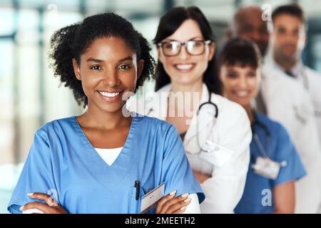 Wir stehen zusammen, damit es dir besser geht. Porträt eines vielfältigen Ärzteteams, das in einem Krankenhaus zusammensteht. Stockfoto