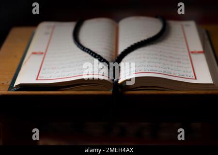 Der Heilige Koran auf dem Rednerpult und den Gebetsketten. Islamisches Foto. Selektiver Fokus. Ramadan-Konzept. Stockfoto