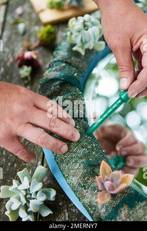 Kranzspiegelrahmen, lebender Spiegelrahmen, mit einem Dibber Löcher in das Netz zu bohren Stockfoto