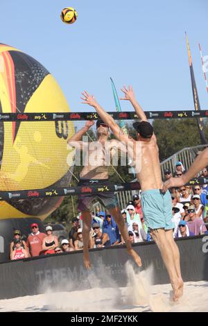 Phil Dalhausser (links) spitzt den Ball, als Tri Bourne (rechts) versucht, ihn während des Herrenfinals bei den AVP Central Florida Open im Hickory zu blockieren Stockfoto