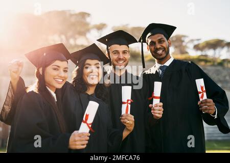 Unser neues Kapitel des Lebens beginnt jetzt. Porträt einer Gruppe von Schülern, die am Abschlusstag mit ihren Diplomen feiern. Stockfoto