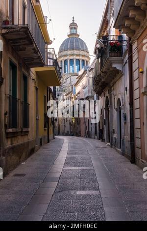 Die Kuppel des Doms von San Giorgio, L'Insigne collegiata di San Giorgio, durch eine kleine Straße der späten barocken Stadt Ragusa Ibla. Stockfoto