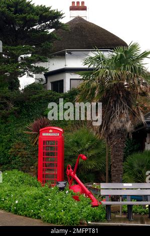 Rote Telefonbox und roter Anker, Paignton, Devon. Stockfoto