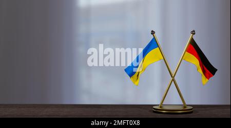 Flaggen der Ukraine und Deutschlands auf dem Tisch. Verhandlungen zwischen Deutschland und der Ukraine. Auf wenig unscharfem Hintergrund. 3D Arbeit und 3D Bild Stockfoto