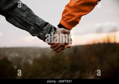 Paar hält sich die Hände während der Fahrt zusammen Stockfoto