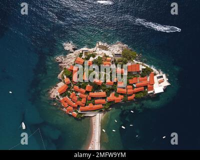 Aerophotographie. Luftaufnahme der Insel Sveti Stefan an an einem wunderschönen Sommertag, Montenegro von der fliegenden Drohne. Panoramablick über St. Stephen Lux Stockfoto