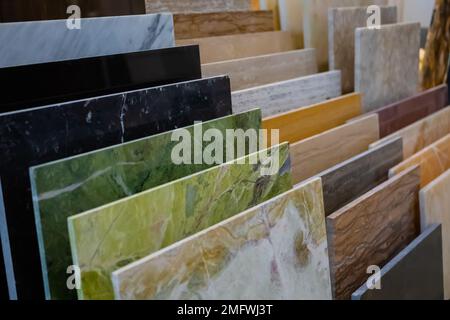 Bunte Granit- und Marmorsteinplatten auf der Theke zum Verkauf im Baumarkt Stockfoto