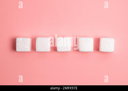 Weiße Styroporwürfel auf dem farbigen Schreibtisch. Brandneue Informationen. Stockfoto