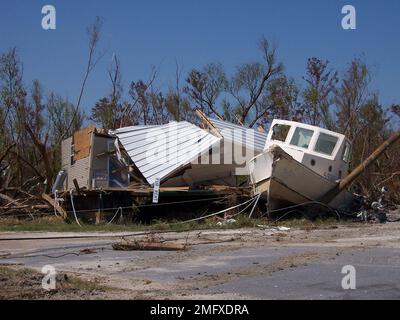 Nachwirkungen - versetzte Boote - Verschiedenes - 26-HK-28-121. Zerstörtes Schiff und Gebäude. Hurrikan Katrina Stockfoto