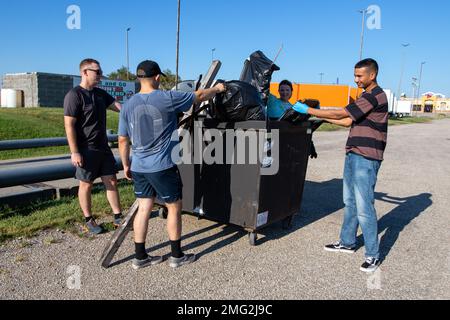 Kandidaten des Fort Riley Sergeant Audie Murphy Club werfen Müll weg, den sie bei einer Gemeindeaufräumung am 20. August 2022 in Junction City, Kansas, gesammelt haben. 1. Soldaten der Infanterie Division zeigen der Öffentlichkeit, dass sie mehr für ihre Gemeinden tun können, indem sie ihre Zeit freiwillig nutzen, um in den Gebieten um Fort Riley einen positiven Einfluss zu erzielen. Stockfoto