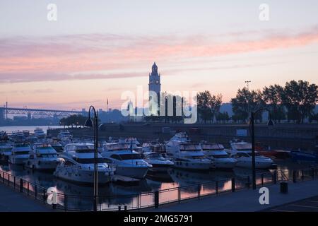 Vertäute Boote am Yachthafen und Uhrenturm bei Sonnenaufgang im Frühjahr, Old Port of Montreal, Quebec, Kanada. Stockfoto