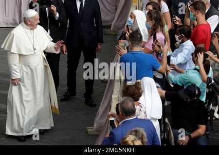 Pope Francis speaks to faithful wearing face masks to prevent the spread of COVID-19 as he arrives for his general audience, the first with faithful since February when the coronavirus outbreak broke out, in the San Damaso courtyard, at the Vatican, Wednesday, Sept. 2, 2020. (AP Photo/Andrew Medichini)