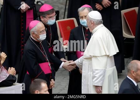 Pope Francis shakes hands with prelates wearing face masks to prevent the spread of COVID-19 during his general audience, the first with faithful since February when the coronavirus outbreak broke out, at the San Damaso courtyard, at the Vatican, Wednesday, Sept. 2, 2020. (AP Photo/Andrew Medichini)