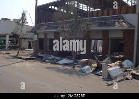 Navigationshilfen - 26-HK-63-44. Stark beschädigtes Gebäude und Schutt entlang der Straße. Hurrikan Katrina Stockfoto