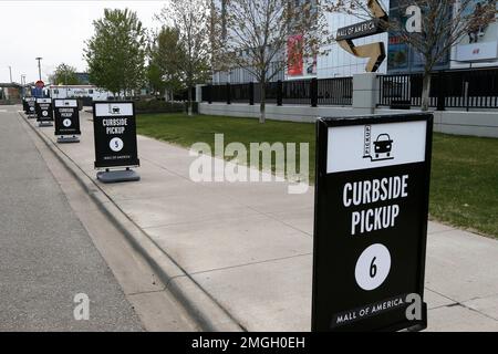 Curbside pickup spots are shown at the Mall of America for shoppers buying online or by phone from some mall stores Tuesday, May 5, 2020, in Bloomington, Minn. (AP Photo/Jim Mone)