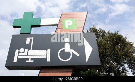 Apotheke Schild grün Cross Store und Krankenhausausstattung und Rollstuhl Logo Verleih Eingang in Downtown City Stockfoto