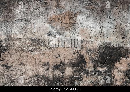 Raue, strukturierte alte Zementwand mit Flecken und Kratzern Stockfoto