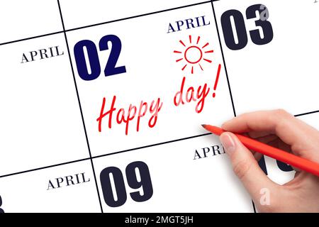 2. April-Tag. Schreiben Sie mit der Hand den Text HAPPY DAY und Drawing the Sun am Kalenderdatum April 2. Merken Sie sich das Datum vor. Feiertage. Motivation. Frühlingsmonat, Stockfoto