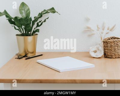 Heimbüro Holzschreibtisch mit Heimdekor und verschiedenen Zubehörteilen. Vorderansicht. Speicherplatz kopieren Stockfoto