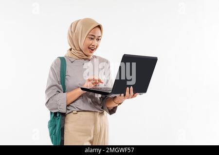 Ein wunderschöner Schüler mit Hijab schockiert, als er den Laptop öffnete Stockfoto