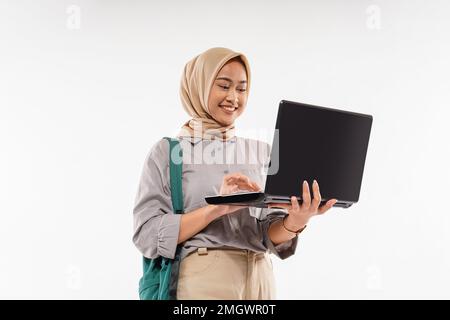 Eine Studentin mit Hidschab öffnete den Laptop mit ihrer Hand Stockfoto