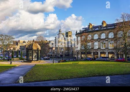 Statuen unter einer Pergola mit Wohnwohnungen, Geschäften und den königlichen Bädern von Baggalley & Bristowe, einem der ältesten denkmalgeschützten Gebäude von Harrogate. Stockfoto