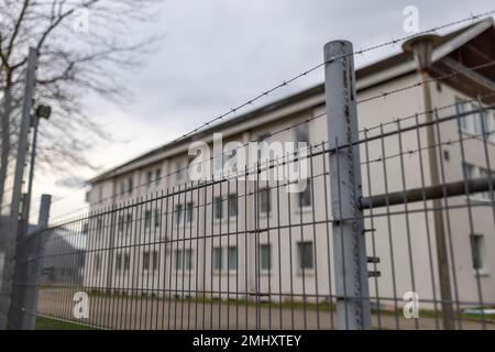 Freiburg, Deutschland. 27. Januar 2023. Ein teilweise mit Stacheldraht versehener Zaun umgibt das Gelände der ursprünglichen staatlichen Aufnahmeeinrichtung (LEA) in Freiburg. Nach Unruhen in der Freiburger Flüchtlingsanlage werden Lösungen gesucht. Die Staatsanwaltschaft, die Polizei und der regionalrat sind beteiligt, und zu diesem Zweck wurde auch eine Sitzung geplant. Seit dem Wochenende gab es mehrere Unruhen in der ursprünglichen Auffangeinrichtung. Kredit: Philipp von Ditfurth/dpa/Alamy Live News Stockfoto