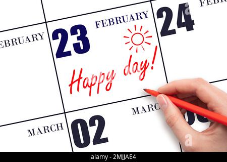 23. Februar. Schreiben Sie mit der Hand den Text HAPPY DAY und Drawing the Sun am Kalenderdatum Februar 23. Merken Sie sich das Datum vor. Feiertage. Motivation. Im Winter Stockfoto