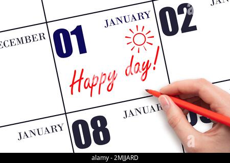 1. Januar-Tag. Schreiben Sie mit der Hand den Text HAPPY DAY und Drawing the Sun am Kalenderdatum Januar 1. Merken Sie sich das Datum vor. Feiertage. Motivation. Wintermond Stockfoto