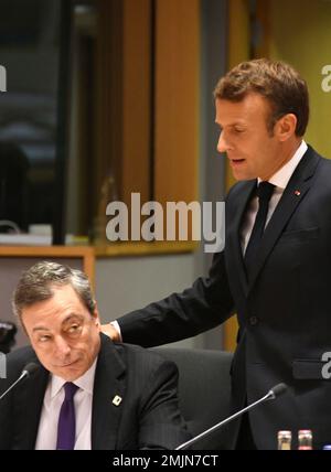 French President Emmanuel Macron, right, speaks with European Central Bank President Mario Draghi during a round table meeting at an EU summit in Brussels, Friday, June 21, 2019. EU leaders conclude a two-day summit on Friday in which they will discuss the euro-area. (AP Photo/Riccardo Pareggiani)