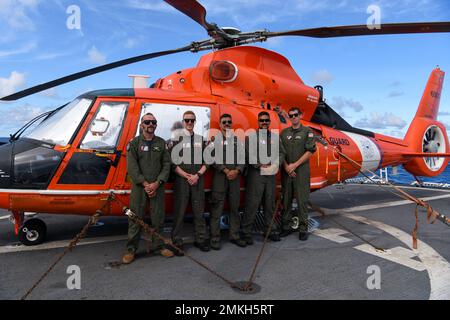 Crew-Mitglieder, die der Küstenwache-Luftstation Houston und Miami zugewiesen wurden, posieren für ein Foto mit dem Hubschrauber MH-65 Dolphin an Bord des USCGC Mohawk (WMEC 913) während des Flugs im Atlantischen Ozean am 9. September 2022. Eine Flugabteilung, die vorübergehend mit dem Mohawk für eine 3-monatige AFRICOM-Patrouille eingesetzt wurde. Stockfoto