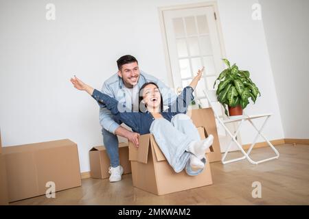 Glückliches Junges Paar, Das Spaß Zusammen Hat, Während Es Nach New Home Zieht Stockfoto