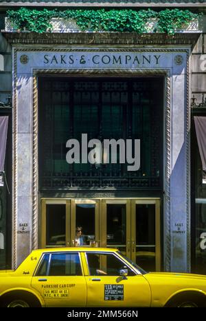 1987 HISTORISCHES GELBES TAXI CAB SAKS KAUFHAUS EINGANG FIFTH AVENUE MIDTOWN MANHATTAN NEW YORK CITY USA Stockfoto