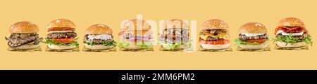 Spezielle Hamburger-Gruppe auf gelbem Hintergrund Stockfoto