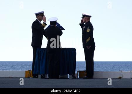 Capt. Derek Fix, Stabschef der Carrier Strike Group 12 (CSG 12), bereitet sich darauf vor, die eingeäscherten Überreste eines Familienmitglieds während einer Beerdigung auf See auf dem Flugzeugelevator 2 des First-in-Class-Flugzeugträgers USS Gerald R. Frod (CVN 78), 17. September 2022, ins Meer zu bringen. Während der Zeremonie wurden die eingeäscherten Überreste von 30 Seelen ins Meer im Atlantischen Ozean gebracht. Ford führt derzeit im Atlantischen Ozean Qualifizierungen von Fluggesellschaften durch und arbeitet für einen geplanten Einsatz im Herbst. Stockfoto