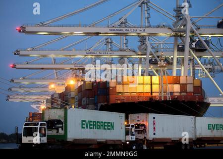 In this June 19, 2018 photo, several ship to shore cranes stack shipping containers on-board the container ship Maersk Semarang while three Ever Green Line refrigerated containers wait to be loaded onto another ship at the Port of Savannah in Savannah, Ga. On Wednesday, Aug. 29, the Commerce Department issues the second of three estimates of how the U.S. economy performed in the April-June quarter. (AP Photo/Stephen B. Morton)