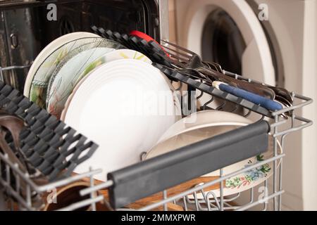 Geschirrspüler mit sauberem Geschirr zu Hause in der Küche, Geschirr waschen, Teller aus der Spülmaschine reinigen Stockfoto