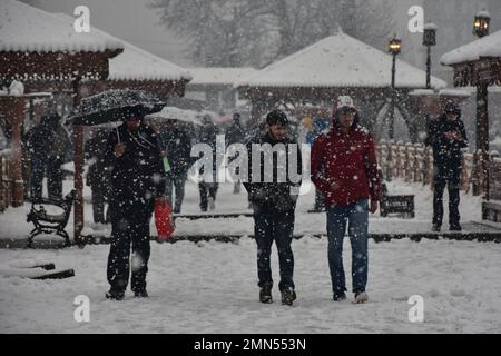 Srinagar, Indien. 30. Januar 2023. Bei Schneefall in Srinagar wandern die Bewohner entlang der schneebedeckten Fußbrücke. Das Kaschmir-Tal war von der Außenwelt abgeschnitten, alle Flüge zum und vom Flughafen Srinagar wurden gestrichen und die Nationalautobahn wurde wegen starkem Schneefall am Montagmorgen gesperrt. Kredit: SOPA Images Limited/Alamy Live News Stockfoto