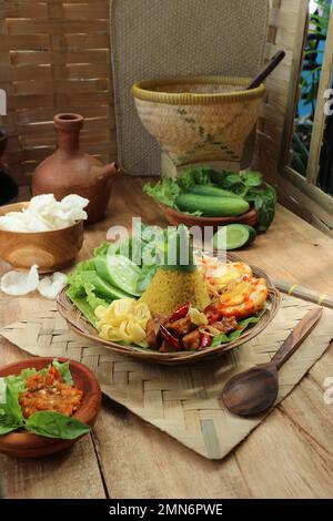 Traditionelles indonesisches Gericht Nasi Tumpeng mit gekochtem Ei und Gemüse Stockfoto